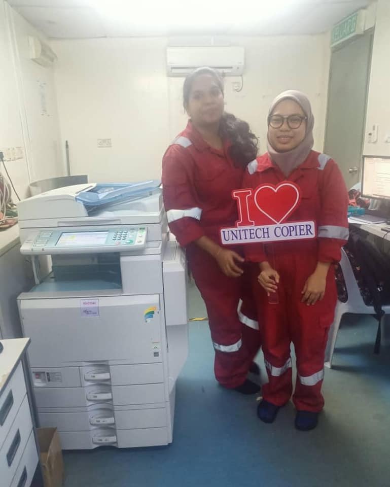 Installing Ricoh color copier at Pasir Gudang site office with beautiful lady